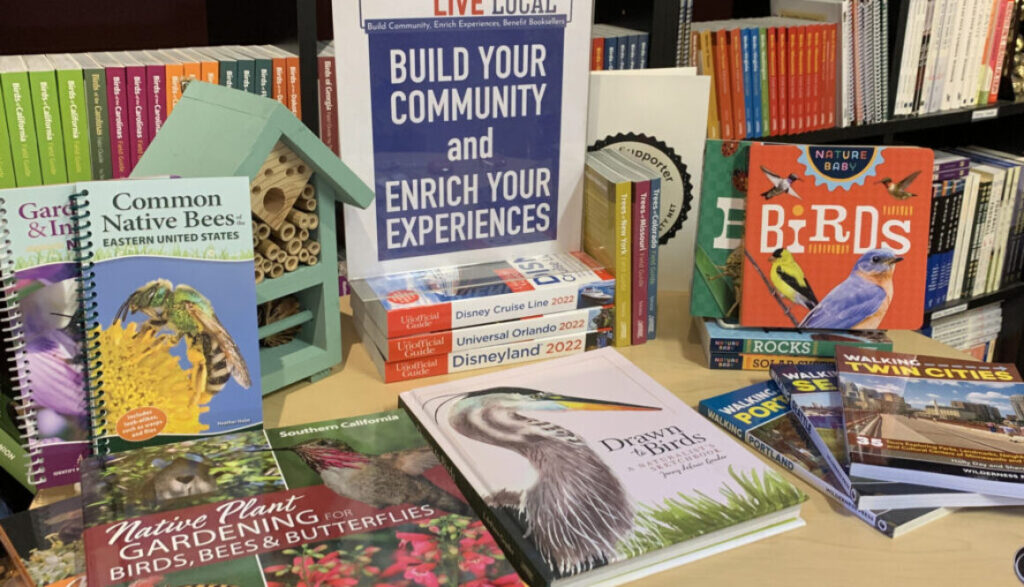 table with books on it and a sign that reads build your community and enrich your experiences